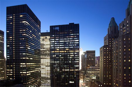 exterior of modern office - Buildings lit up at dusk in downtown Manhattan looking north, New York City, New York State, USA Stock Photo - Premium Royalty-Free, Code: 6105-05953780