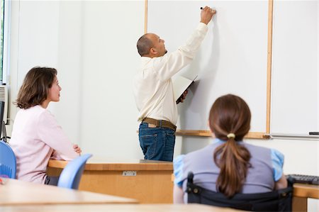 Engineering student presenting at whiteboard Stock Photo - Premium Royalty-Free, Code: 6105-05953703