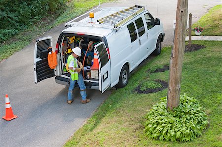 road truck transport - Communications worker preparing to climb pole at his truck Stock Photo - Premium Royalty-Free, Code: 6105-05953736