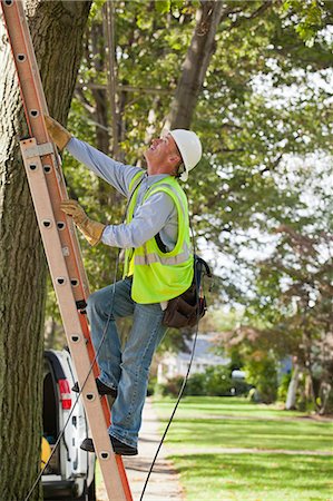 powerline worker - Lineman climbing a ladder to work on wires Stock Photo - Premium Royalty-Free, Code: 6105-06042938