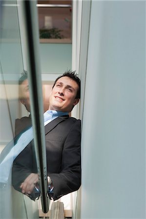 simsearch:693-07456224,k - Businessman leaning on the stairwell of an office building Stock Photo - Premium Royalty-Free, Code: 6105-06043089