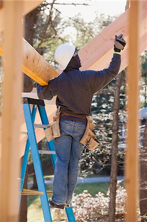 people carrying the ladder - Carpenter lifting beam for roof Stock Photo - Premium Royalty-Free, Code: 6105-06043019