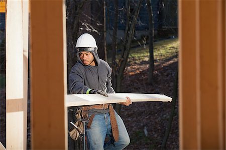 people constructing buildings - Carpenter carrying a board Stock Photo - Premium Royalty-Free, Code: 6105-06043035