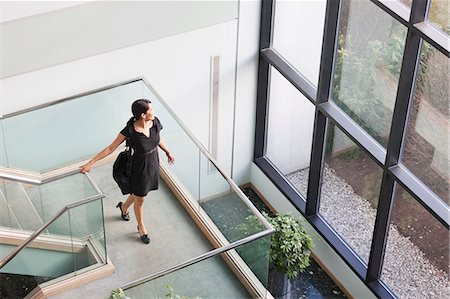 railing top view - Hispanic businesswoman with briefcase on stairs on office building Stock Photo - Premium Royalty-Free, Code: 6105-06043106