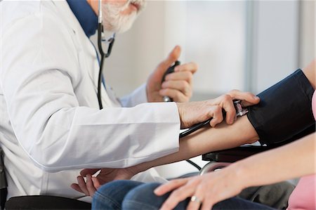 Doctor checking the blood pressure of a patient Stock Photo - Premium Royalty-Free, Code: 6105-06043119