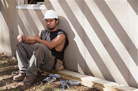 Hispanic carpenter taking a break at construction site Stock Photo - Premium Royalty-Free, Code: 6105-06702883