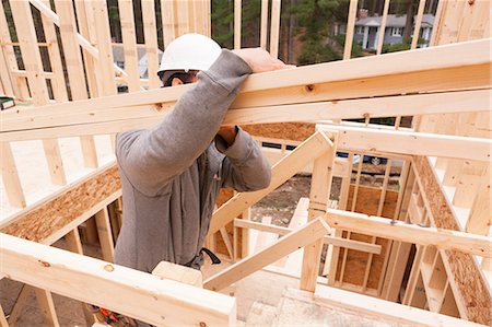 playboy men - Carpenter carrying studs up stairway Stock Photo - Premium Royalty-Free, Code: 6105-06702820