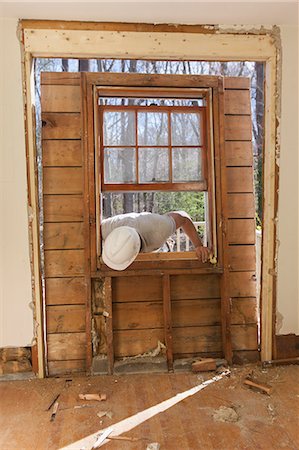 simsearch:6105-06702940,k - Hispanic carpenter removing newly cut door access to deck on home Stock Photo - Premium Royalty-Free, Code: 6105-06702945