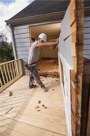 safety home - Hispanic carpenter removing newly cut door access to deck on home Stock Photo - Premium Royalty-Free, Code: 6105-06702954