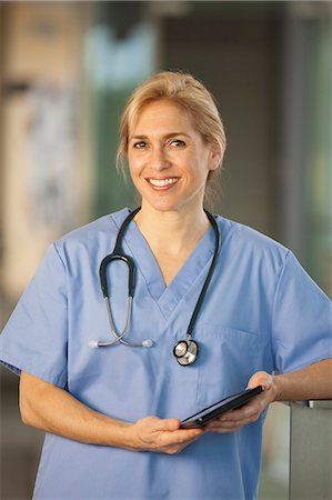 female doctor smiling - Portrait of a female nurse holding a digital tablet Stock Photo - Premium Royalty-Free, Code: 6105-06702992