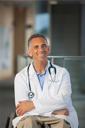 Doctor in wheelchair with spinal cord injury Stock Photo - Premium Royalty-Free, Code: 6105-06702994