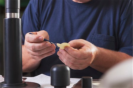 desk with monitor - Engineer installing new membranes in an O2 electrochemical sensor probe in a laboratory Stock Photo - Premium Royalty-Free, Code: 6105-06703109