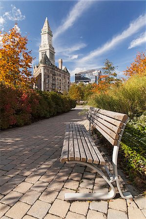 Bench in a park with buildings in the background, Rose Kennedy Greenway, Custom House, Grain Exchange Building, Boston, Massachusetts, USA Stock Photo - Premium Royalty-Free, Code: 6105-06703200