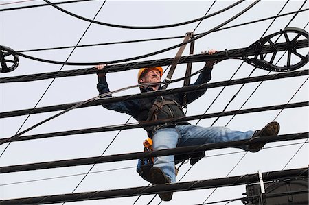 pole - Communications worker adding cables to a bundle Stock Photo - Premium Royalty-Free, Code: 6105-07521253