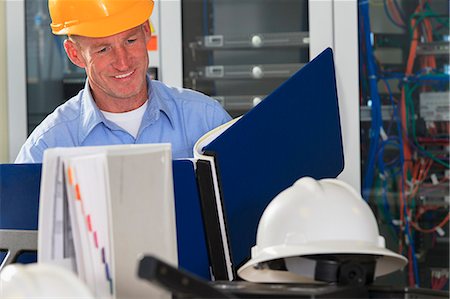 person in wheelchair at home - Electrical engineer reviewing data logs in broadband communication hub Stock Photo - Premium Royalty-Free, Code: 6105-07521458