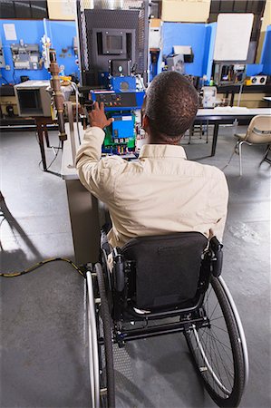 engineer at industry control room - Student in wheelchair studying furnace electronic control system in HVAC classroom Stock Photo - Premium Royalty-Free, Code: 6105-07521497