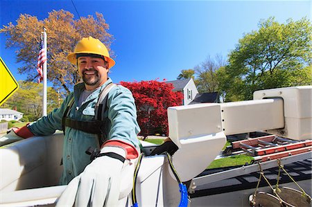 simsearch:6105-07521406,k - Power engineer in lift bucket with safety equipment for power lines at truck level Stock Photo - Premium Royalty-Free, Code: 6105-07521414