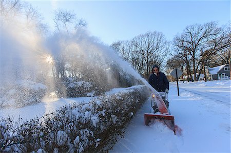 photos of people pushing a person - Middle aged man using snow blower after storm Stock Photo - Premium Royalty-Free, Code: 6105-07744470