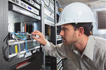 router - Network engineer working in a server room Stock Photo - Premium Royalty-Free, Code: 6105-07744477