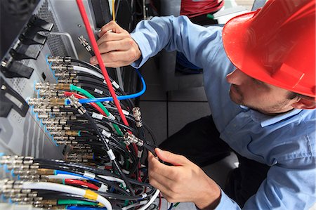 server - Network engineer holding BNC cable connection at patch panel Stock Photo - Premium Royalty-Free, Code: 6105-07744488
