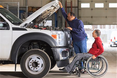 service trucks - Automotive maintenance technician and supervisor with spinal cord injury in truck garage Stock Photo - Premium Royalty-Free, Code: 6105-07744430