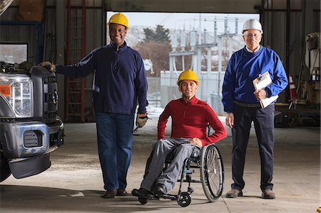 simsearch:6113-07565110,k - Engineers one with spinal cord injury and supervisor at electric Power Plant garage Stock Photo - Premium Royalty-Free, Code: 6105-07744434