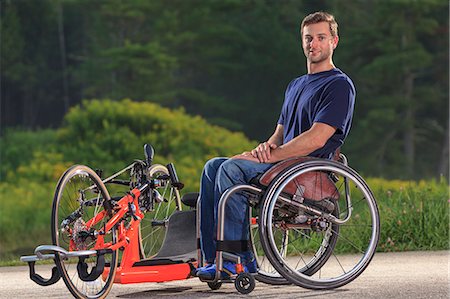 Man with spinal cord injury in his wheelchair with his custom adaptive hand cycle Photographie de stock - Premium Libres de Droits, Code: 6105-08211280