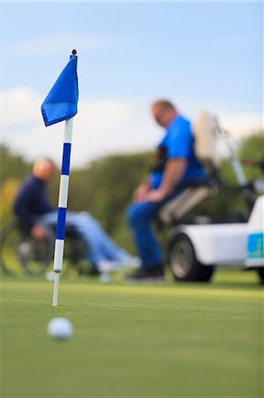 simsearch:6105-05396581,k - Two men with spinal cord injuries waiting at golf putting green Photographie de stock - Premium Libres de Droits, Code: 6105-08211338