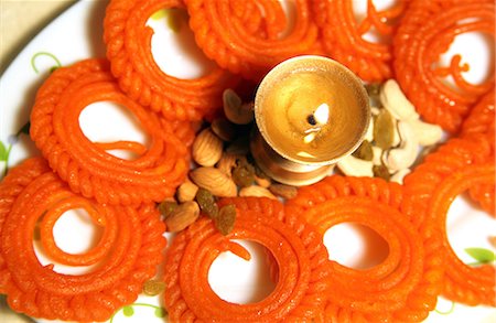 decorative plate - Close-up of Diya and sweets decorated in a plate Stock Photo - Premium Royalty-Free, Code: 6107-06117547