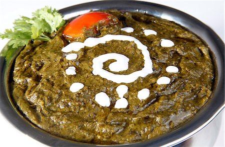 Close-up of sarson ka saag garnished with butter Stock Photo - Premium Royalty-Free, Code: 6107-06117537