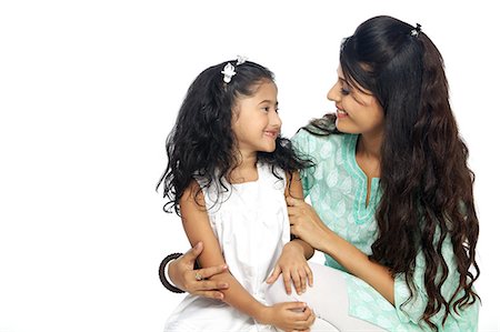 east indian mother and children - Portrait of mother and daughter smiling Stock Photo - Premium Royalty-Free, Code: 6107-06117864