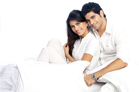 people sitting cutout white background - Portrait of happy couple with pillows Stock Photo - Premium Royalty-Free, Code: 6107-06117901