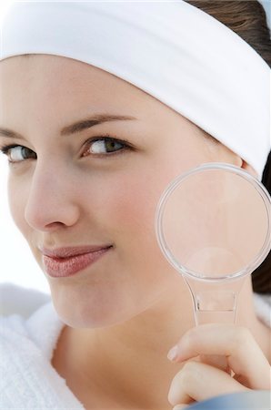 Woman with a magnifying glass Stock Photo - Premium Royalty-Free, Code: 6108-05855676