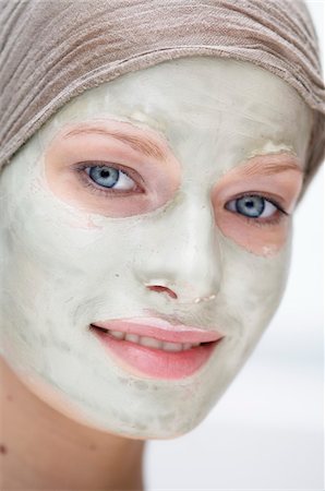 Portrait of a young woman with beauty mask on her face Stock Photo - Premium Royalty-Free, Code: 6108-05855762