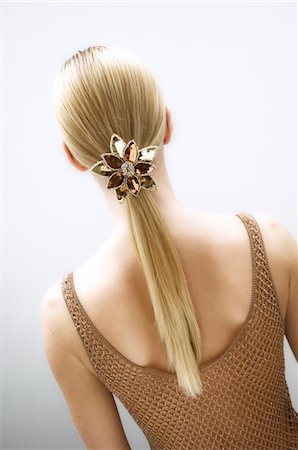 simsearch:6108-05855781,k - Young woman, view from the back, slide in her blond hair (studio) Stock Photo - Premium Royalty-Free, Code: 6108-05855785