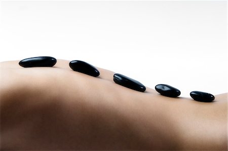 Naked woman lying, with peebles on her back, close up (studio) Foto de stock - Sin royalties Premium, Código: 6108-05855875