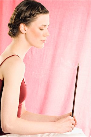 Woman holding incense stick Stock Photo - Premium Royalty-Free, Code: 6108-05855964