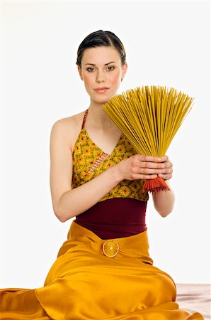 simsearch:6108-05855964,k - Woman holding incense sticks Foto de stock - Sin royalties Premium, Código: 6108-05855965