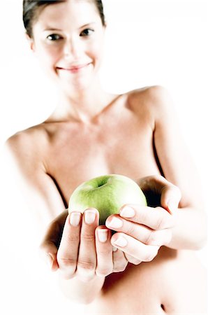 Naked woman holding a green apple, (studio) Stock Photo - Premium Royalty-Free, Code: 6108-05855914