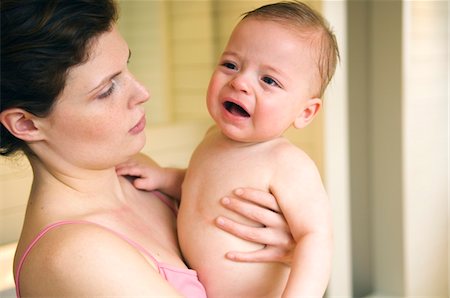 Woman and naked baby crying Fotografie stock - Premium Royalty-Free, Codice: 6108-05856055