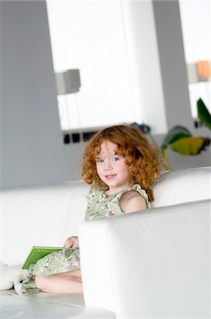 simsearch:6109-06194272,k - Little girl sitting on a sofa Stock Photo - Premium Royalty-Free, Code: 6108-05856060