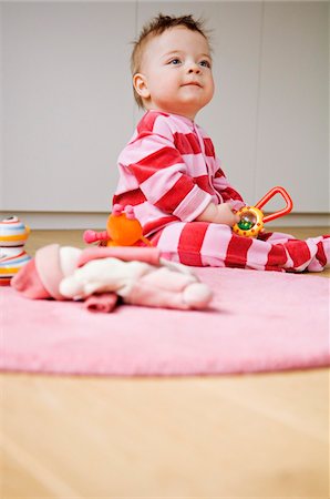 rattle - Baby playing, sitting on the floor Stock Photo - Premium Royalty-Free, Code: 6108-05856024