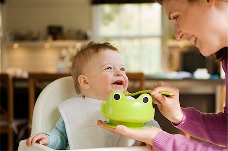 spoon in woman hand - Mother feeding her baby Stock Photo - Premium Royalty-Free, Code: 6108-05856026