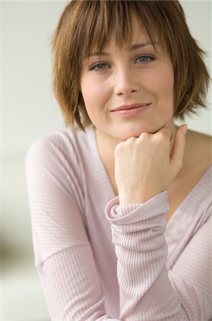 short hair brunette woman - Portrait of a young woman looking at the camera Stock Photo - Premium Royalty-Free, Code: 6108-05856469