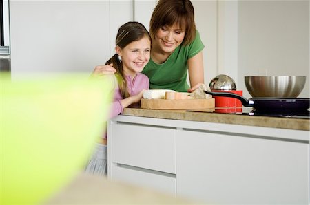 family cheese - Woman and little girl in the kitchen, preparing cheese tray Stock Photo - Premium Royalty-Free, Code: 6108-05856674