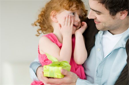 dad gifted kid - Man giving present to little girl Stock Photo - Premium Royalty-Free, Code: 6108-05856691