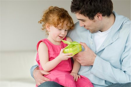 family modern - Man giving present to little girl Stock Photo - Premium Royalty-Free, Code: 6108-05856692