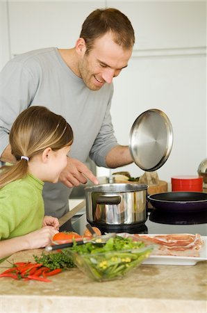 dad and kids cook - Man and little girl coooking Stock Photo - Premium Royalty-Free, Code: 6108-05856610