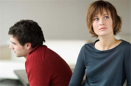 disputation - Sad looking couple in a living-room Stock Photo - Premium Royalty-Free, Code: 6108-05856763