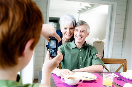 simsearch:6108-05858176,k - Boy taking picture of senior couple with camera phone Stock Photo - Premium Royalty-Free, Code: 6108-05856854